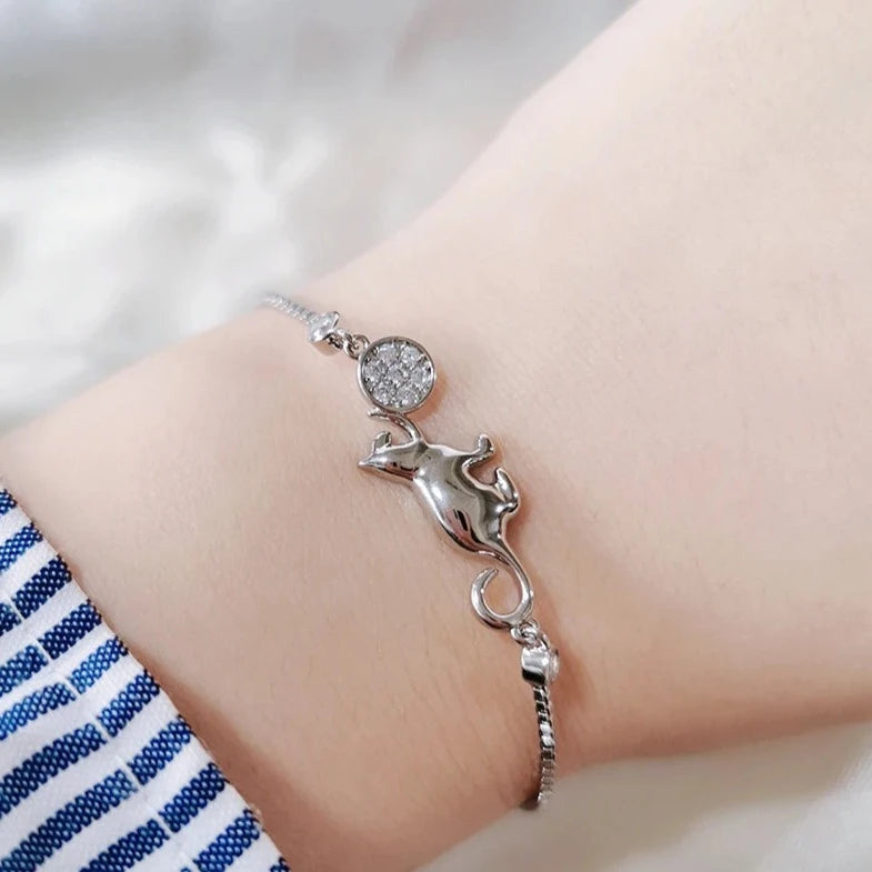 silver purrplay bracelet, on hand, top view